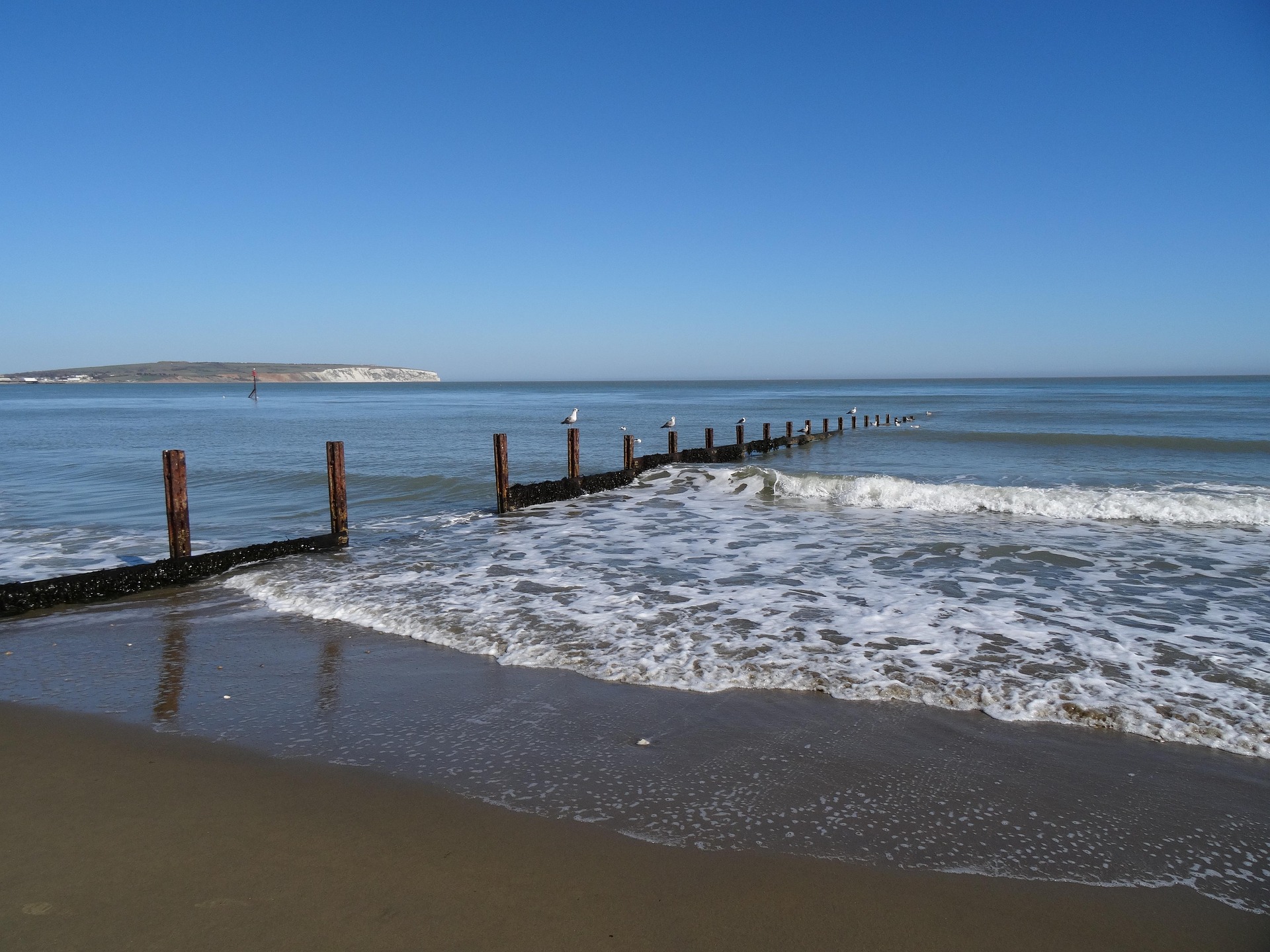 sandy beach blue sky soft waves