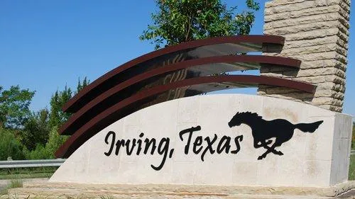 Welcome sign for Irving, Texas featuring a black mustang silhouette and modern architectural design — symbolizing the city's dynamic real estate and community appeal.