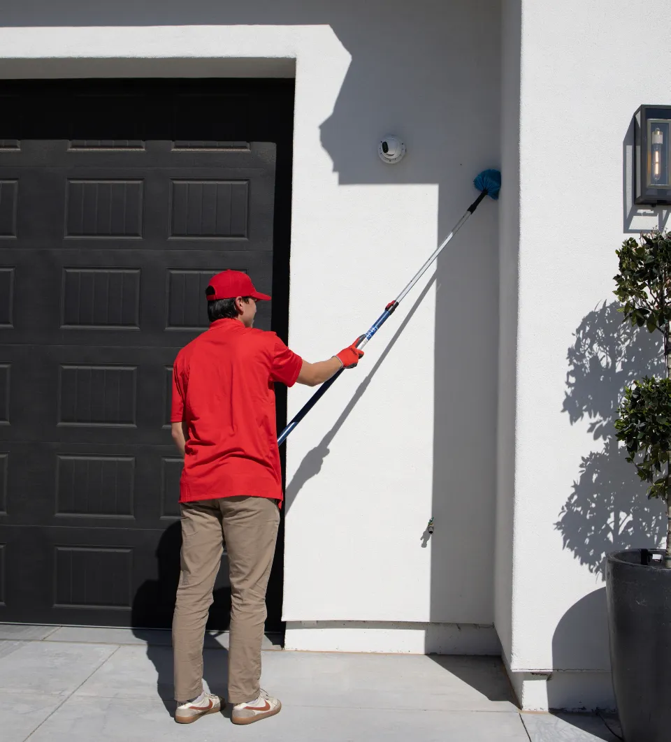 Arsenal Pest Control technician treating the exterior of a Queen Creek home