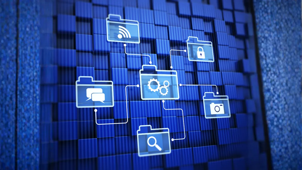 woman in black sweater holding white and black vr goggles