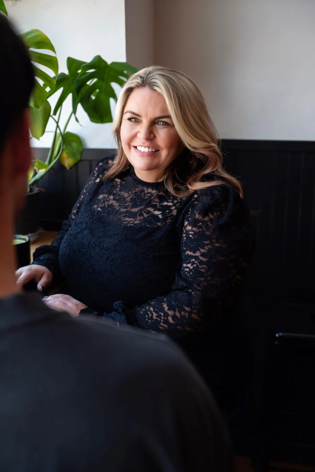 Executive business consultant guiding a small business growth strategy session in a modern daylight studio