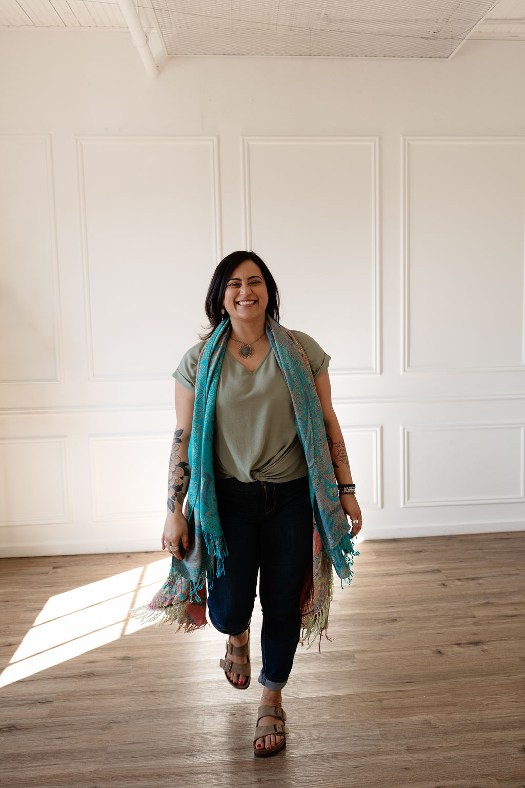 Nikki from Detourin, smiling in a calm, nature-inspired setting