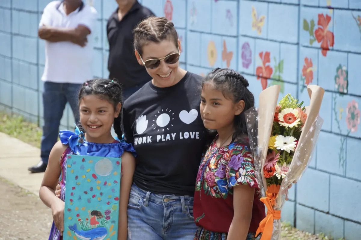 A woman and two children are at a Work.Play.Love event, focused on adoption in Guatemala