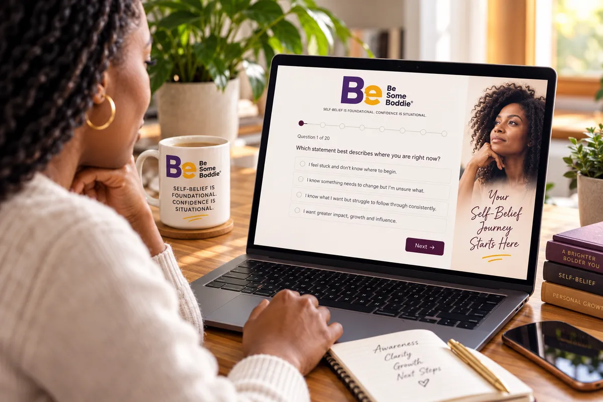 alt text for image please Black woman completing the Be Some Boddie® Self-Belief Pathway Assessment™ on a laptop, reflecting on questions about her self-belief journey in a warm, welcoming workspace.