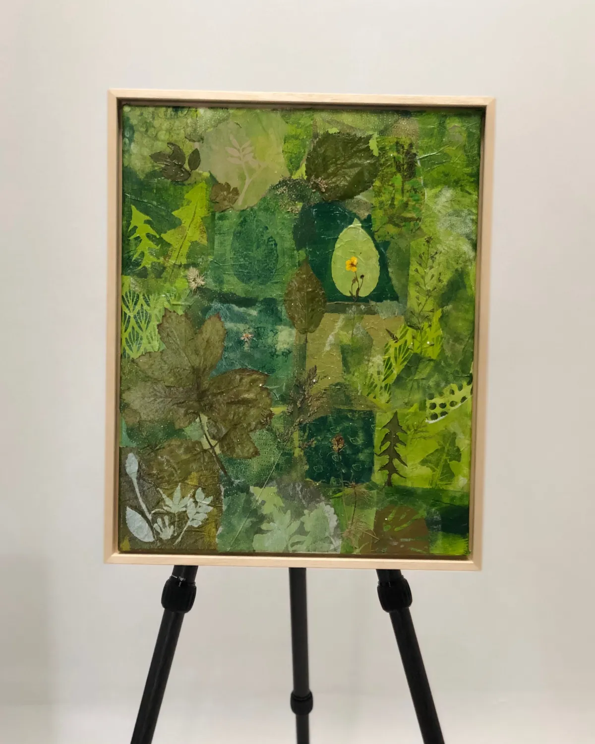 Green mixed media painting build with layers from collection  Natural Flow presented on an easel