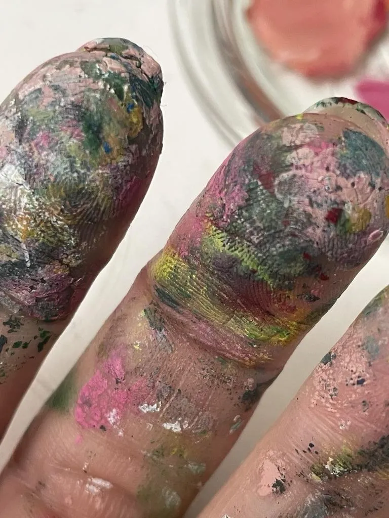 dirty with paint covered fingers
