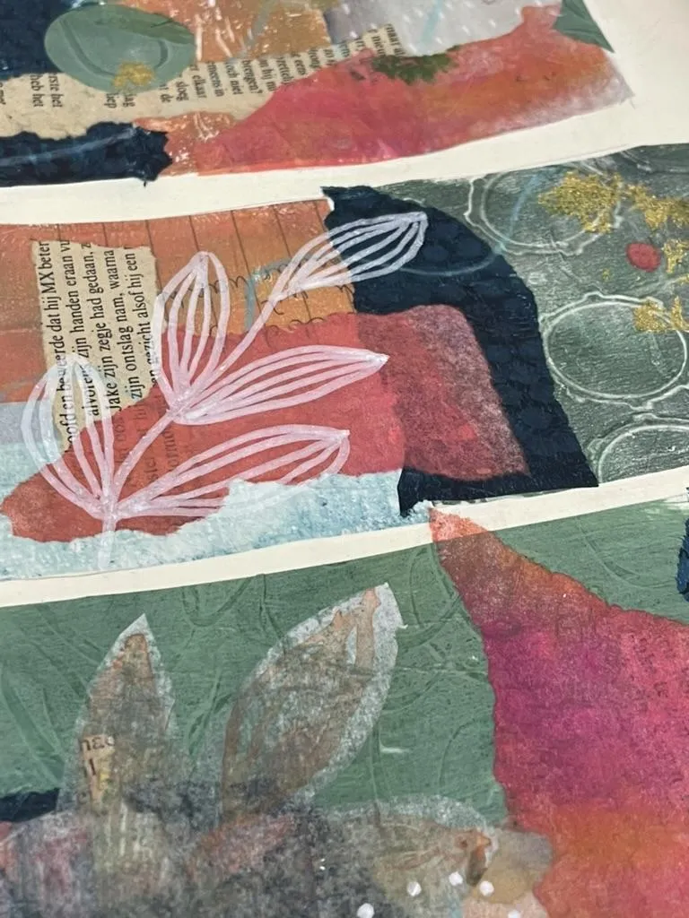 layered collage with pink, blue and green and papers from an old book