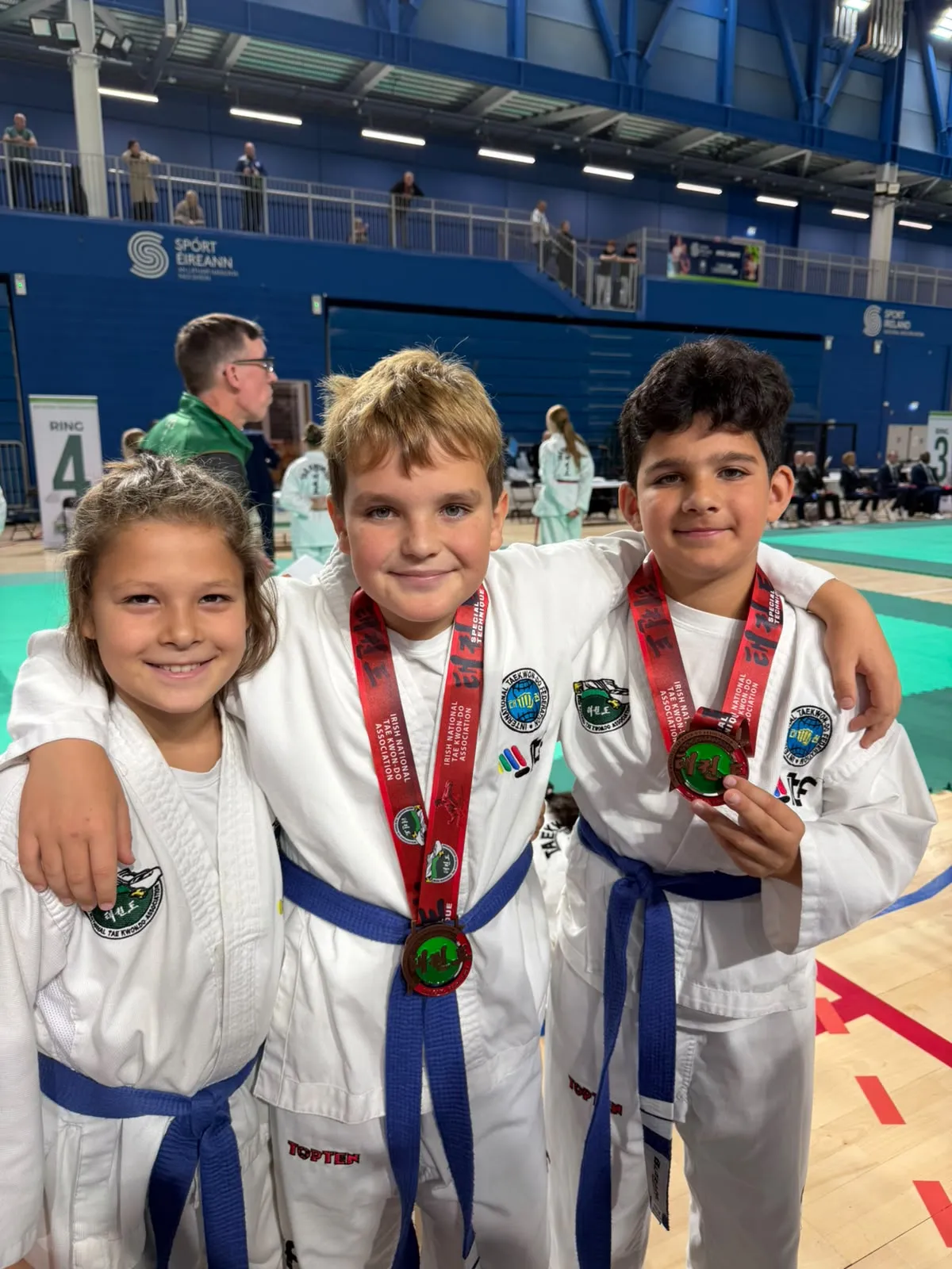 Three Elite Taekwon-Do Academy students together at the 2026 INTA Open Championships