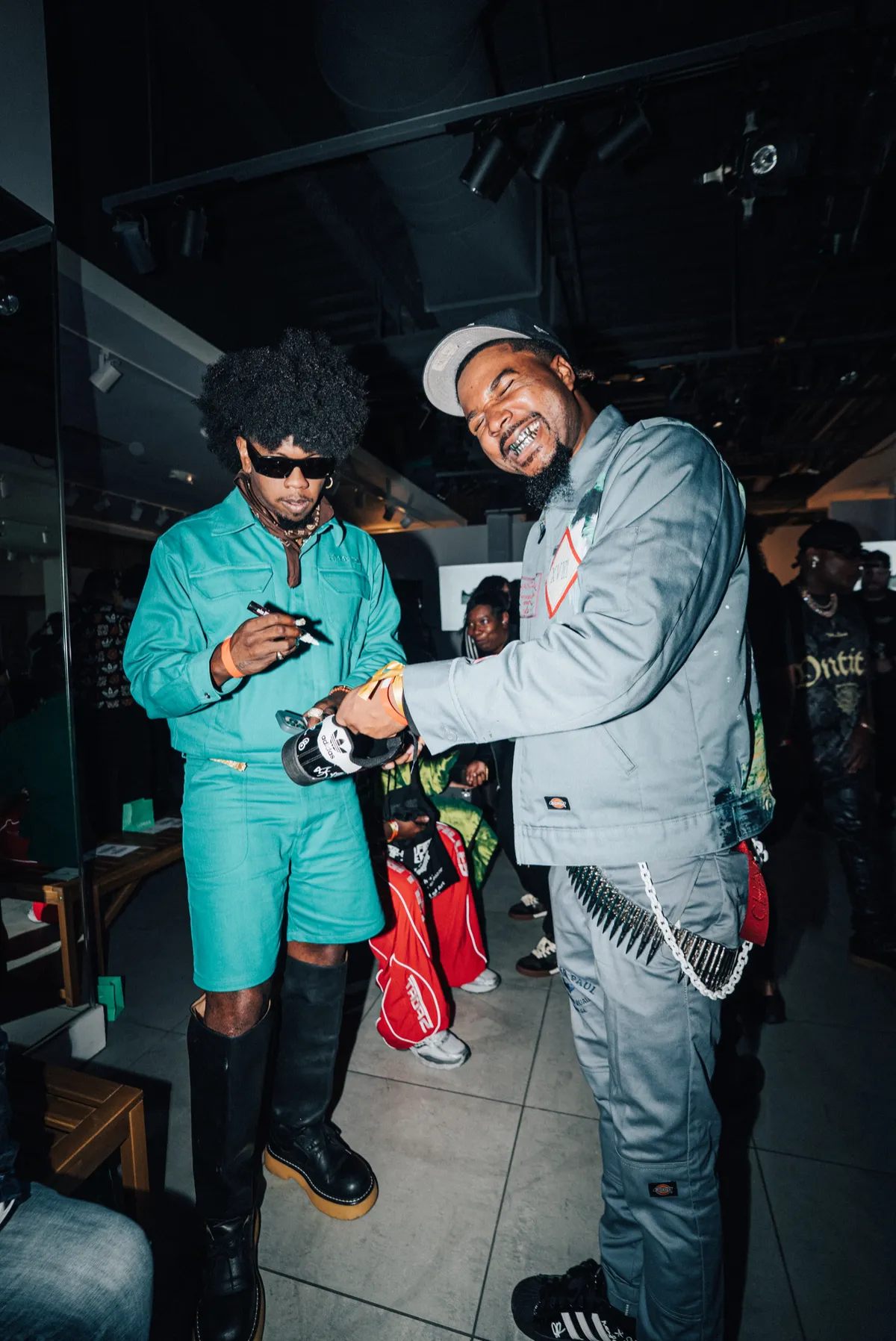 Trinidad James signing a pair of adidas for a guest at the show