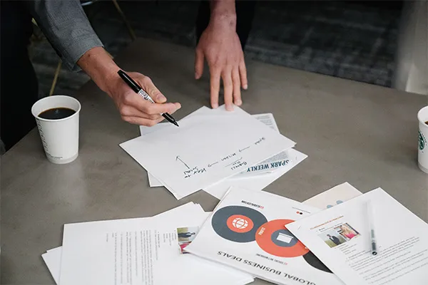 Physical therapist analyzing paperwork to choose a marketing agency for their clinic