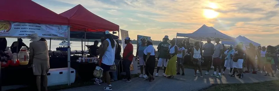 Tastys Temptation food station serving guests at a busy outdoor event