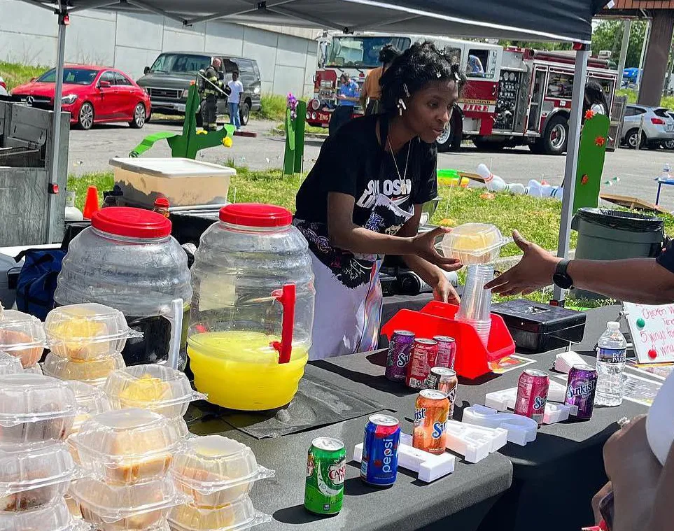 Tastys Temptation staff preparing and serving food at an outdoor market