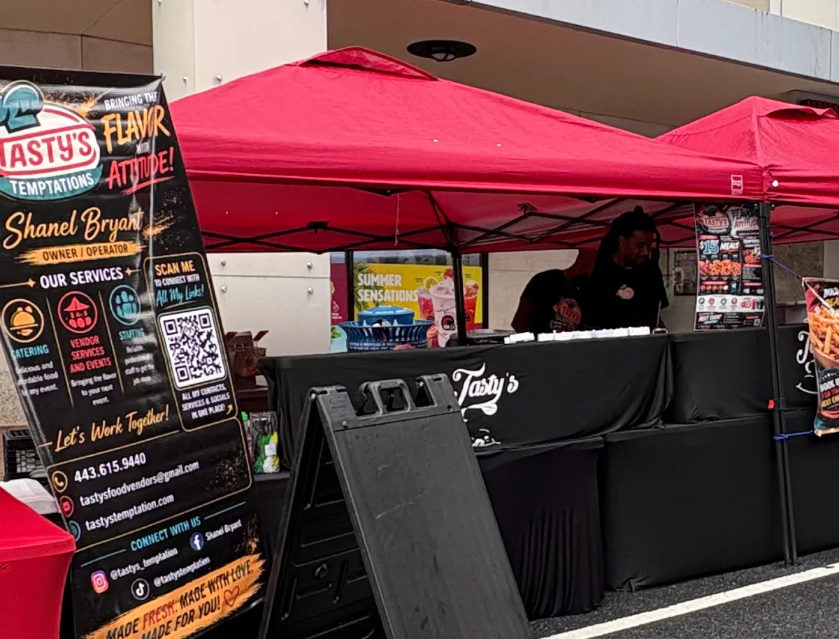Tastys Temptation branded food service setup at an outdoor event