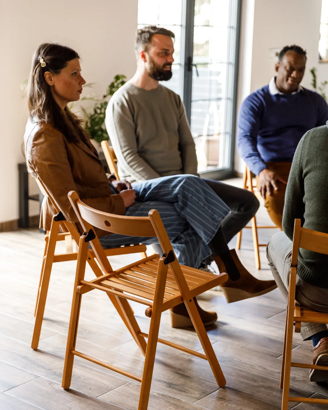 A supportive group discussing personal growth in the Rebuilders Graduate Program.