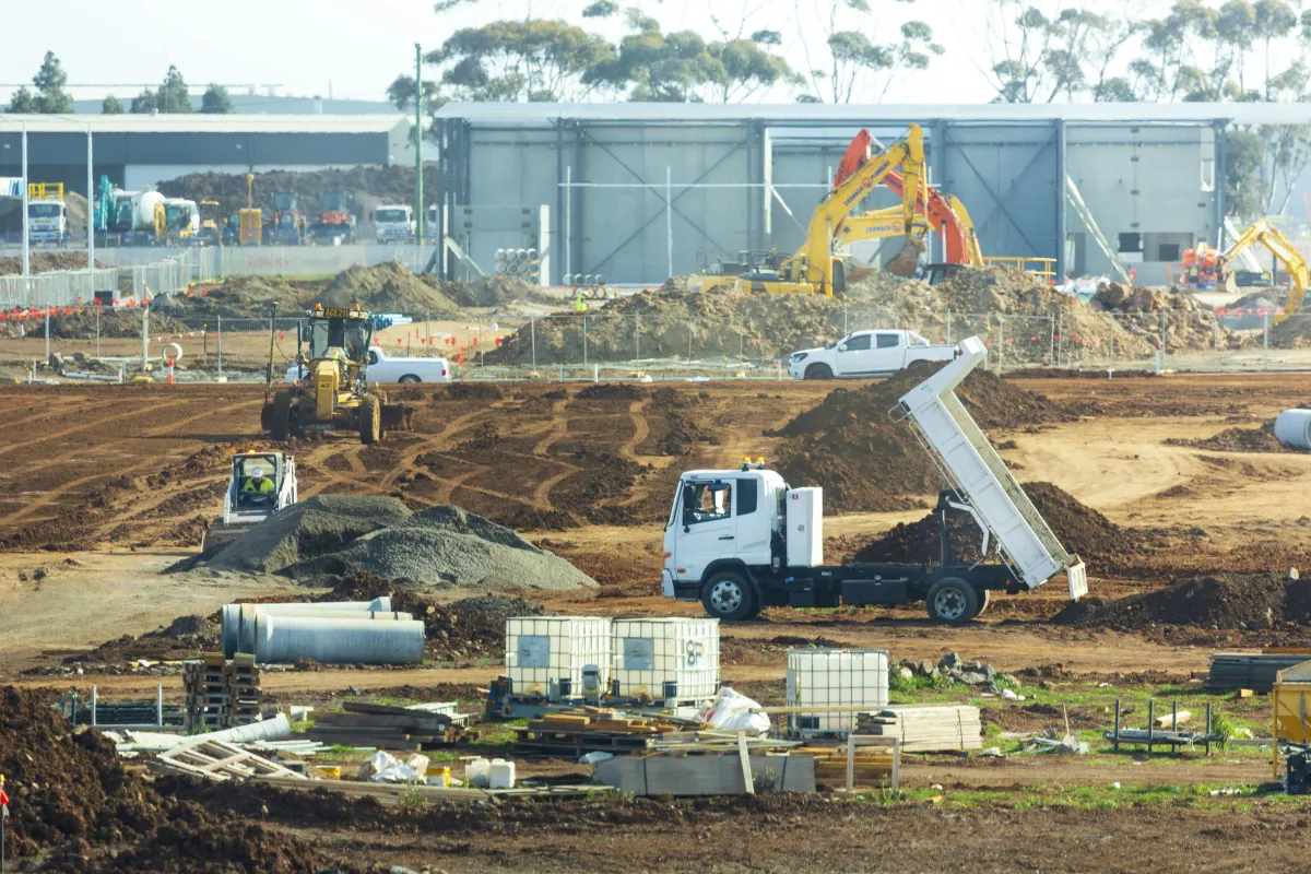 Warehouses near data center construction representing AI-linked industrial leasing demand