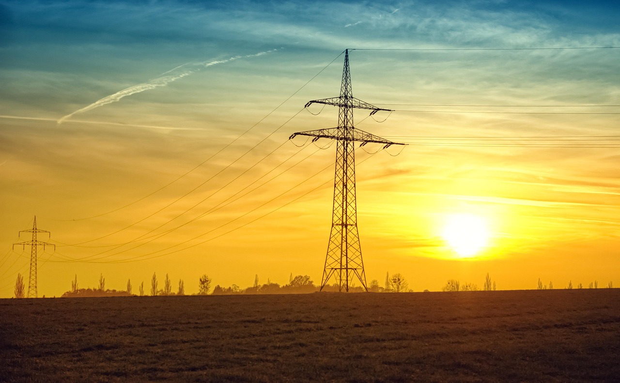 Utility transmission and distribution lines against a backdrop of a commercial district