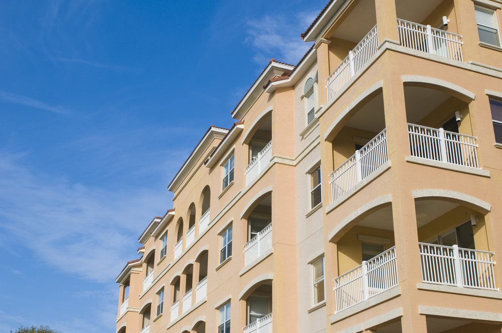 Stock photo representation of South Florida condo building with stacked balconies and multiple unsold units, commonly financed using a bridge loan for unsold condo inventory.