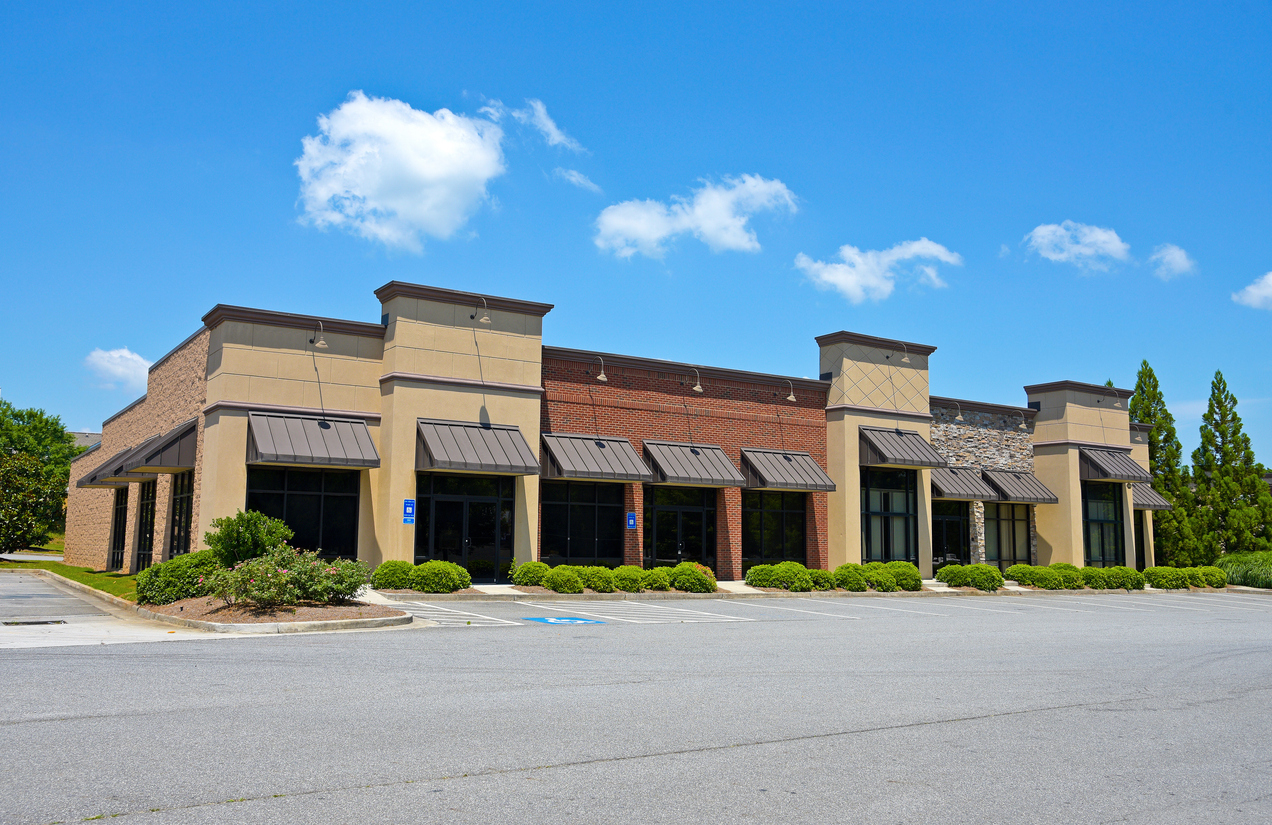 Strip center commercial property with open retail bays ideal for bridge financing during stabilization.