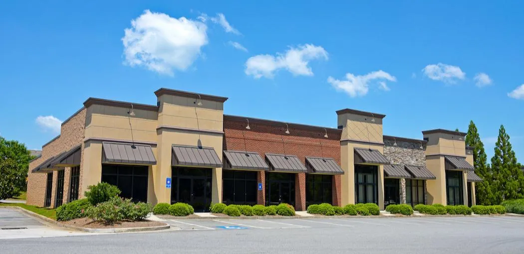 Modern shopping center strip of retail units positioned for tenant improvements and occupancy growth