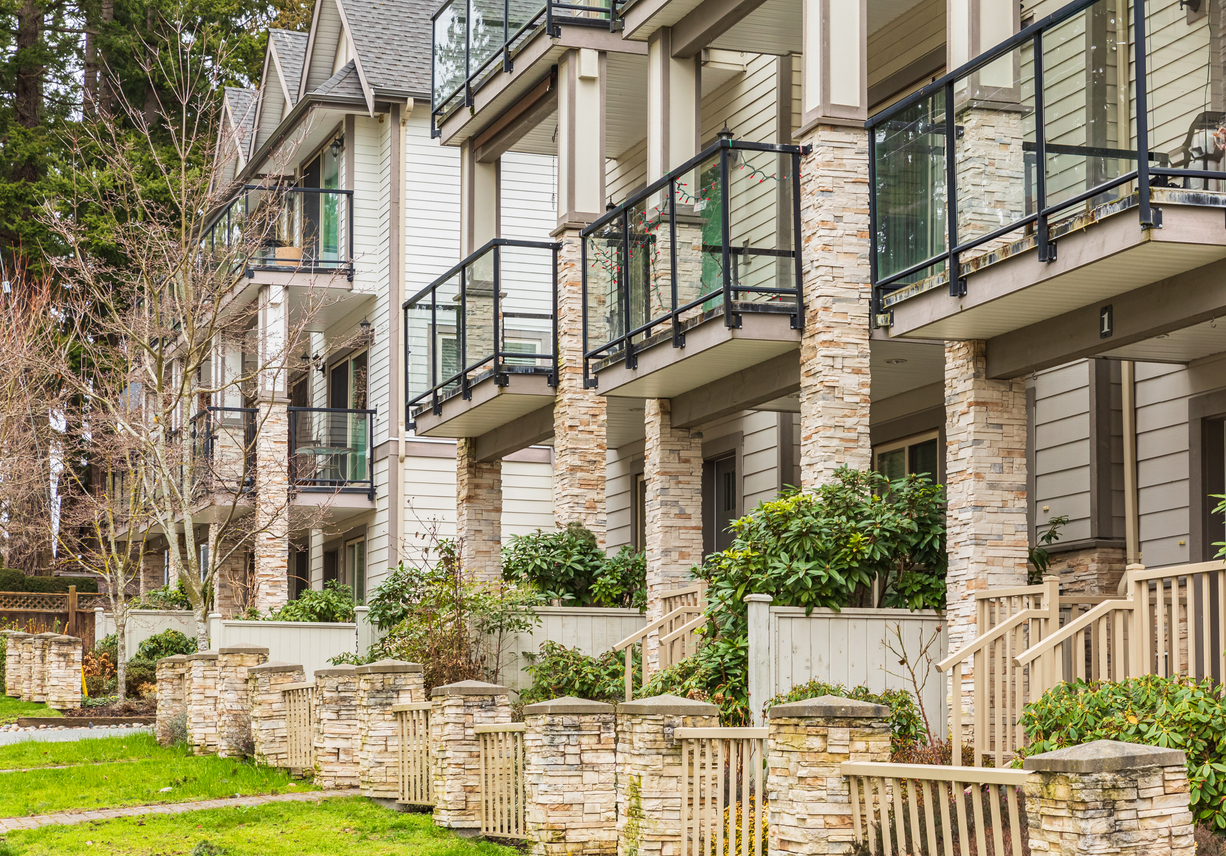 Mid-rise Florida condo with shiplap-style exterior and screened balconies, suitable for bridge loan for unsold condos and bulk condo inventory loan Florida.