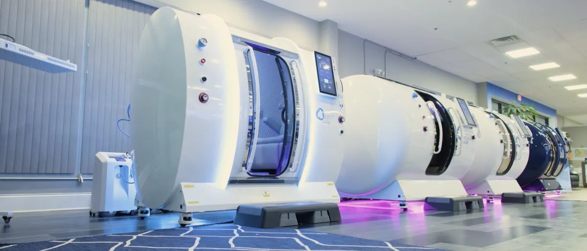 A row of multiplayer hyperbaric oxygen chambers in our showroom in different colors white blue black