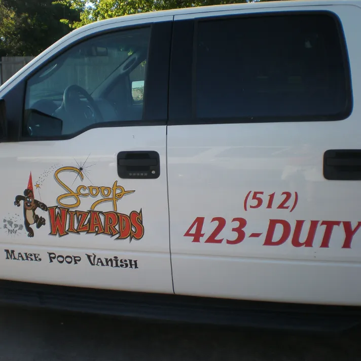 Scoop Wizards truck proudly displaying the company logo, ready to serve your yard.