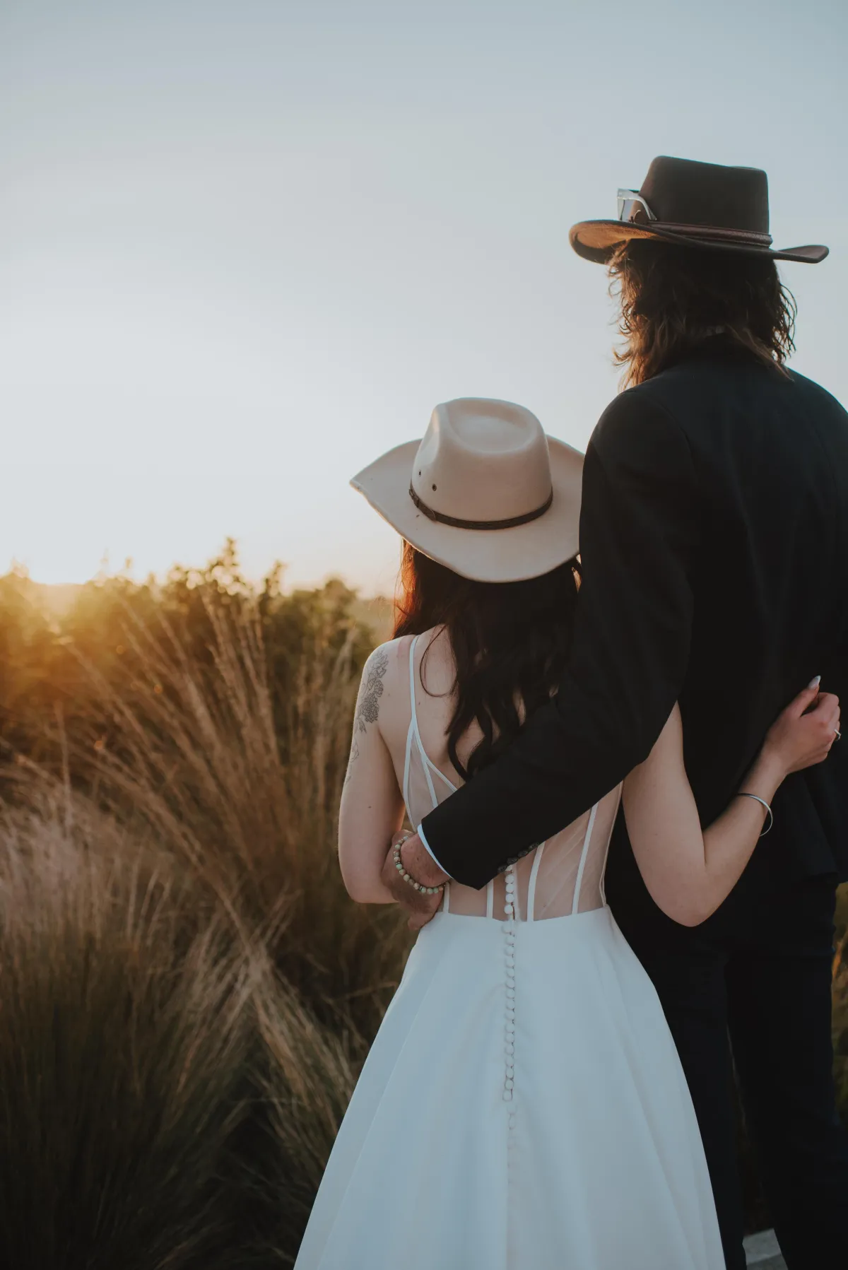 a moment captured of newlyweds staring into the sunset