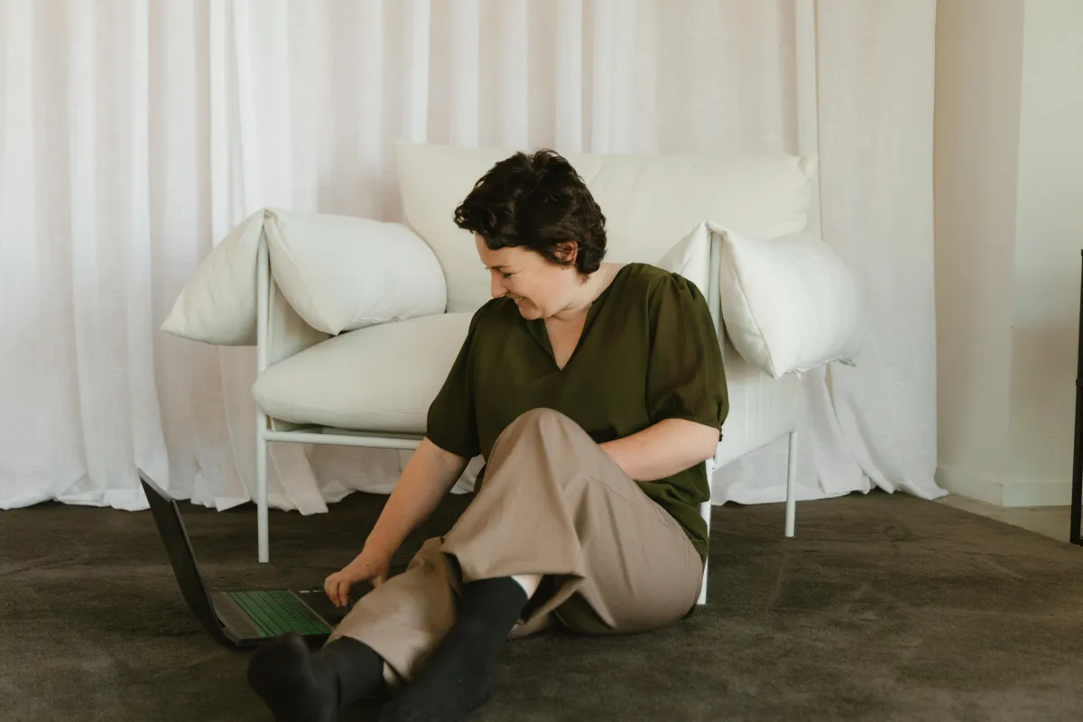 person sitting down with their laptop