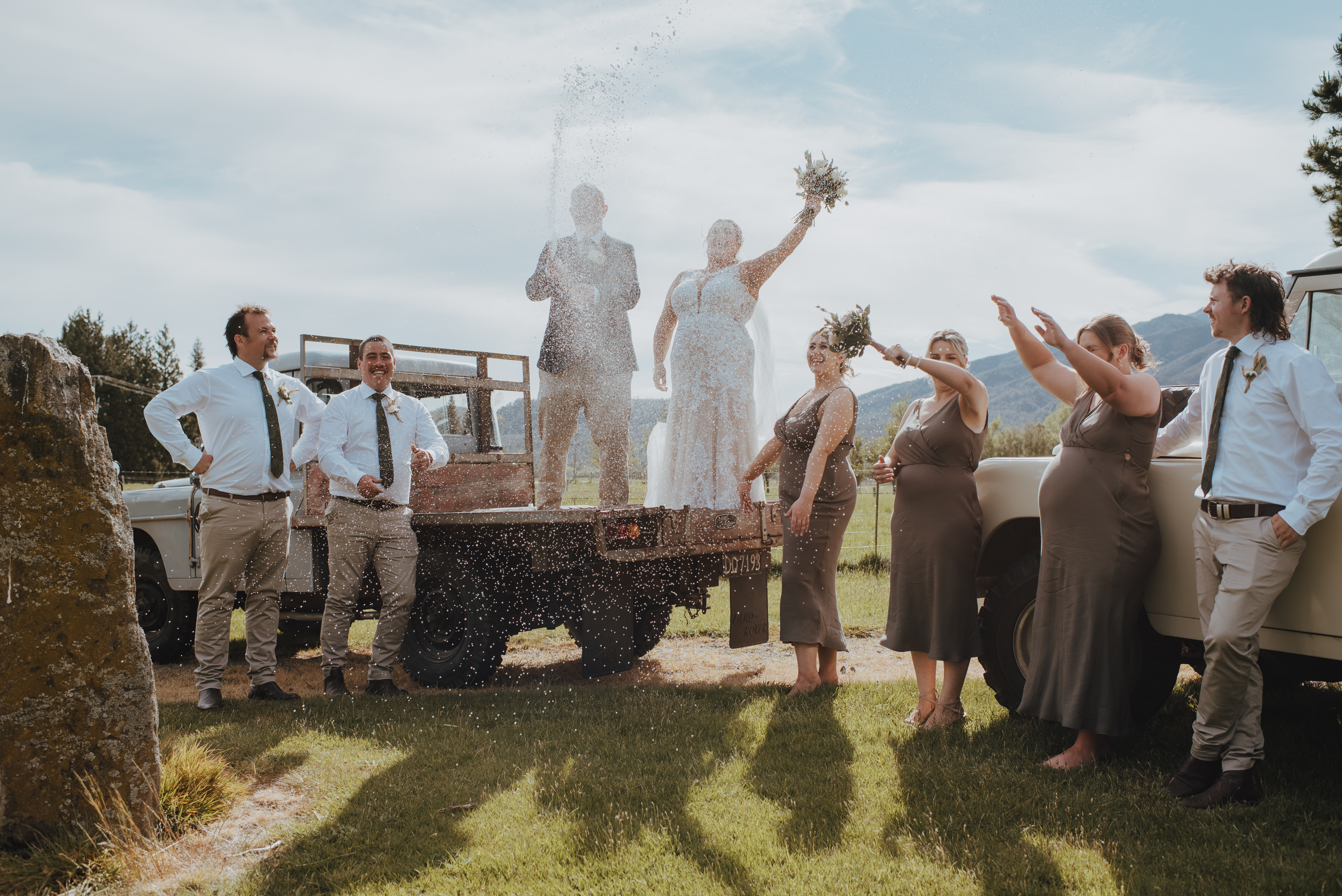 bridal party celebrating with a champagne pop