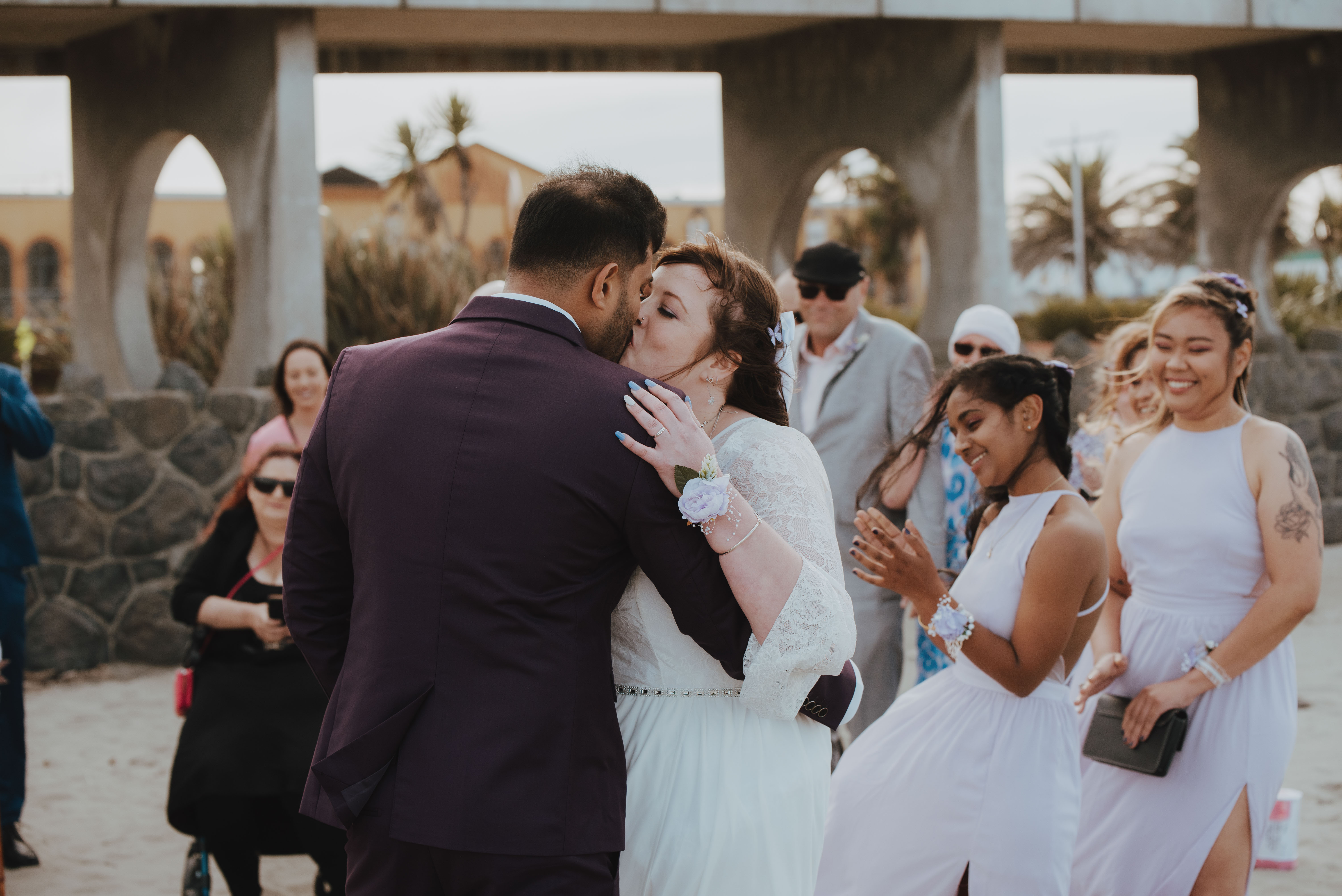 couple sealing with a kiss at beach wedding