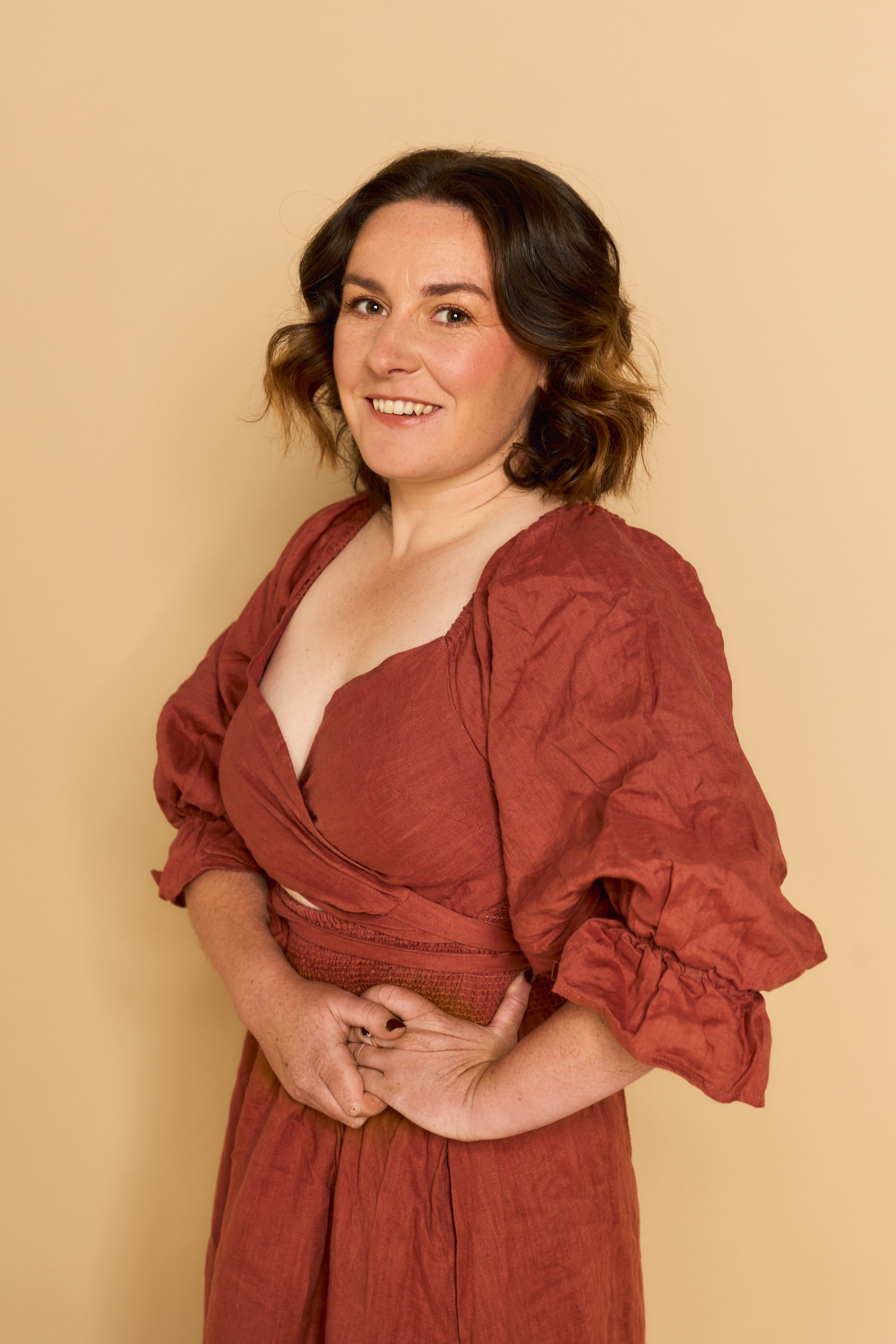 new zealand wedding and boudoir photographer smiling while photographing a couple