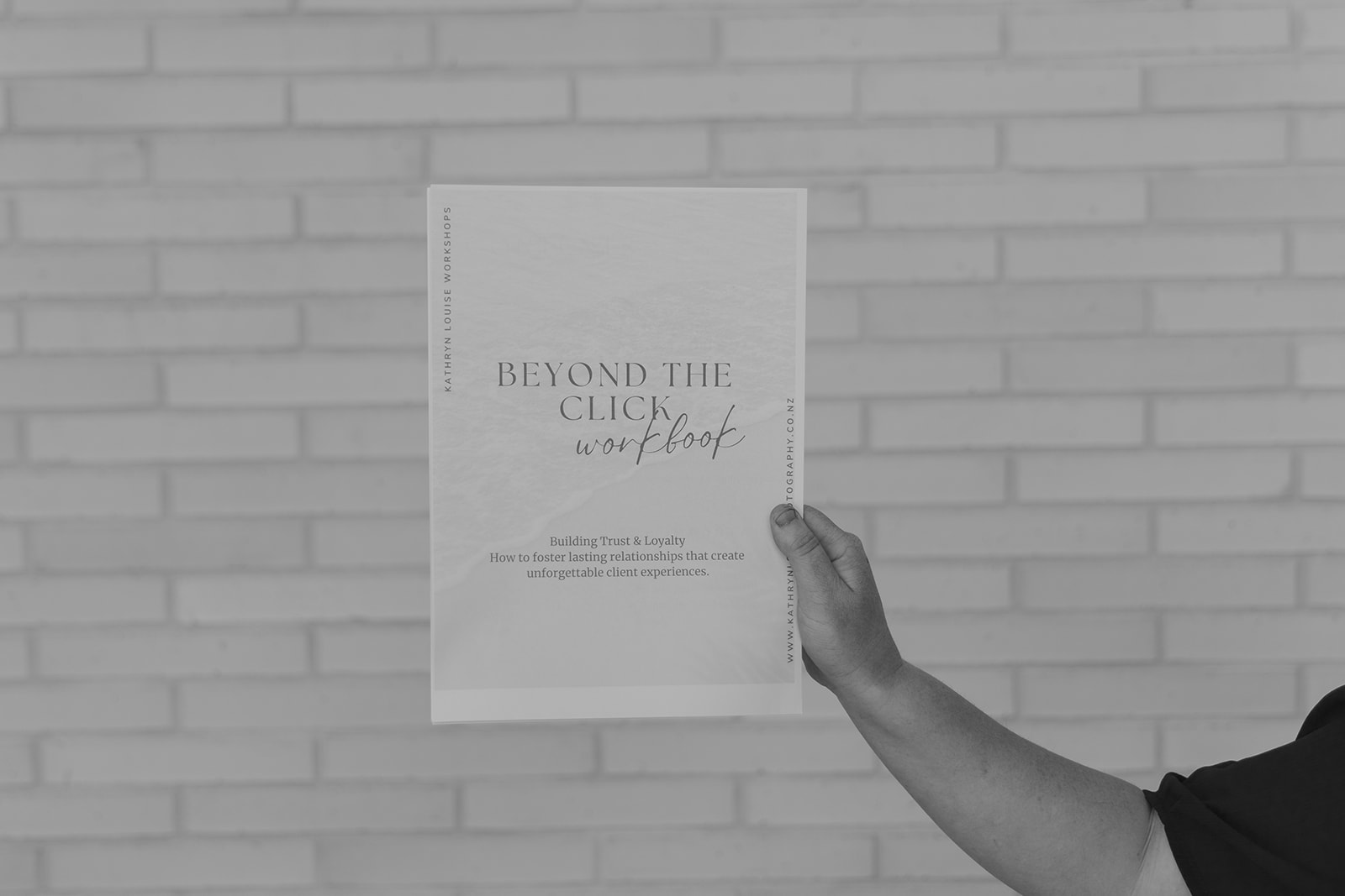person holding up an example workbook