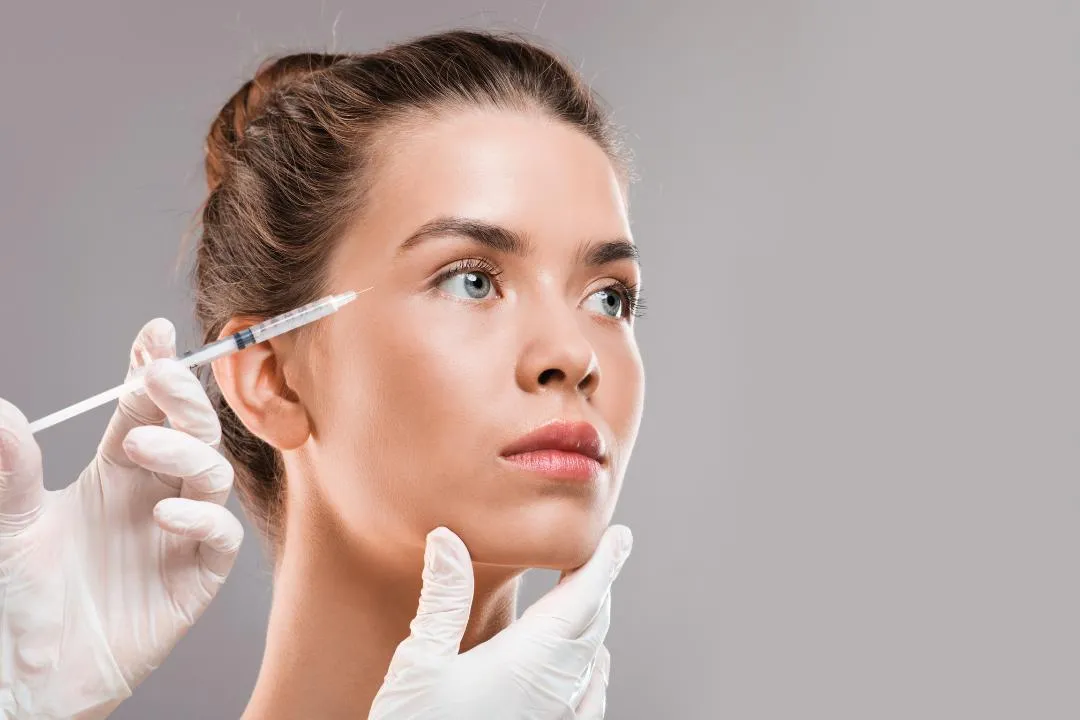 Woman receiving cosmetic injection near eye area, symbolizing key topics to discuss with a licensed Botox provider before treatment..