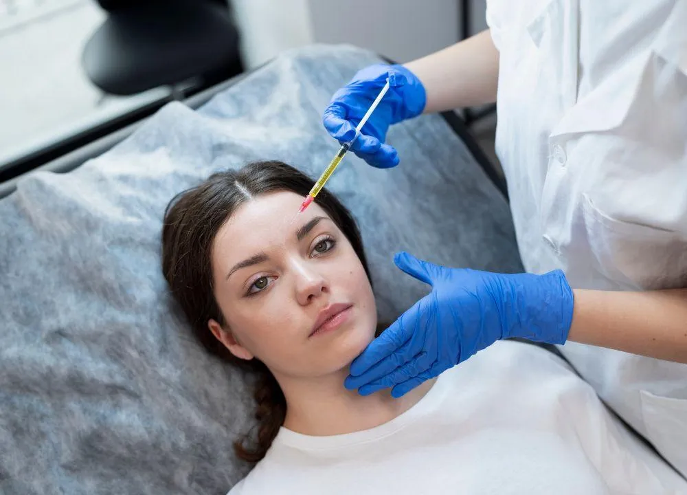 Patient receiving PRP therapy injection on the forehead at a med spa, ideal for adults in Cary seeking natural skin rejuvenation, hair restoration, and joint pain relief without surgery.