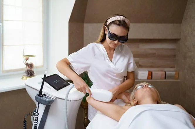 A professional performing IPL treatment on a client at a spa, targeting skin concerns like pigmentation, fine lines, and sun damage for smoother skin.