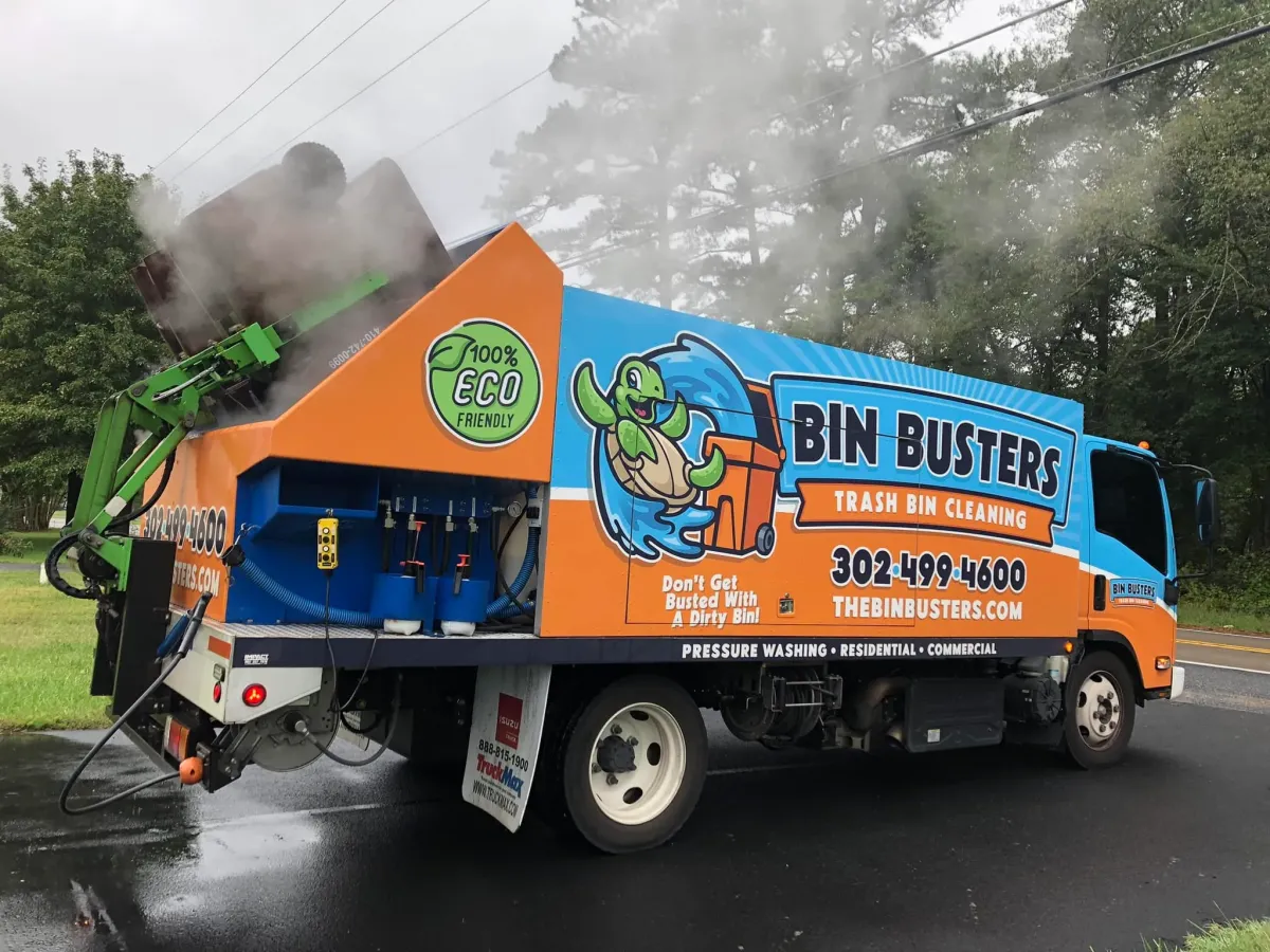 Bin Busters trash can cleaning truck in action using eco-friendly high-pressure cleaning.