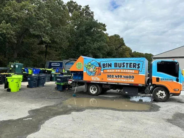 Bin Busters trash bin cleaning truck providing eco-friendly bin cleaning services near a waterfront location