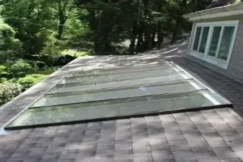 Multi-panel glass skylight installation viewed from above on a residential roof