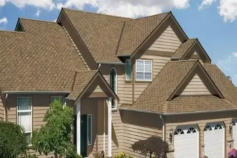 Two-story home with completed tan architectural shingle roof and matching siding