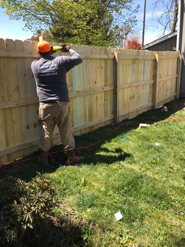 Fence repair services in Urbana OH fixing damaged wood fence by Jordan’s Straight Line Fencing LLC