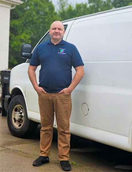 Igor from Inspire Appliance Repair standing in front of his work van
