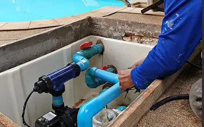 Pool pump repair on blue PVC plumbing in an equipment pit from Canyon Lake Pool Service