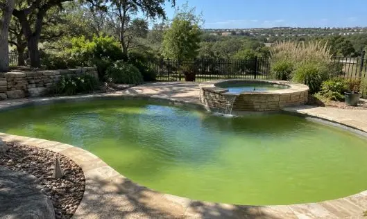 Algae-filled pool and spa awaiting green pool cleanup from Canyon Lake Pool Service