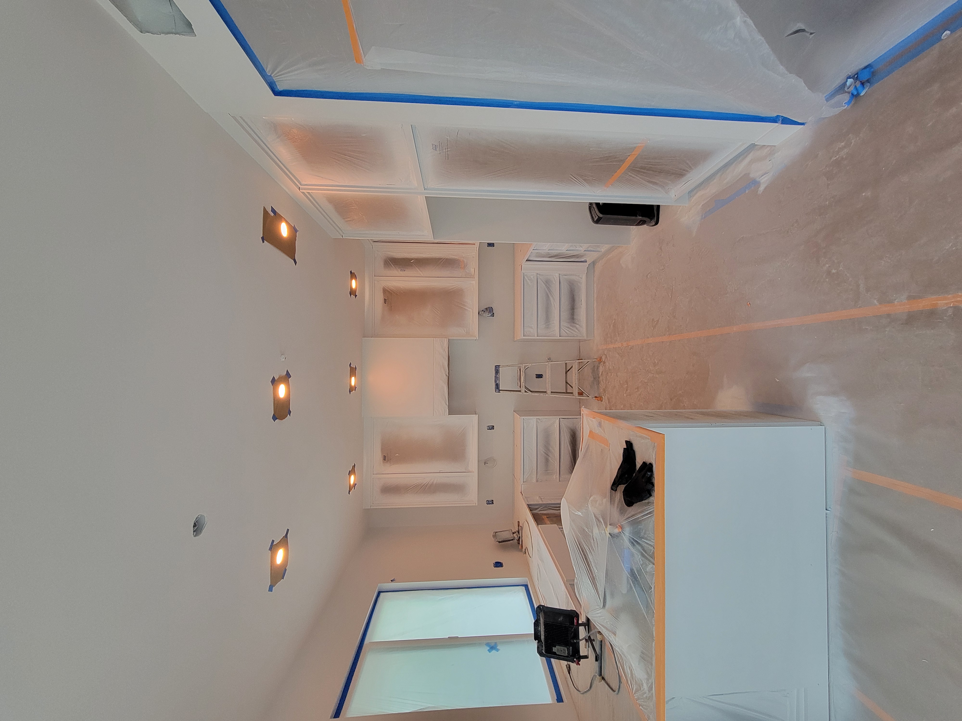 Artist guiding student painting at easel in studio.