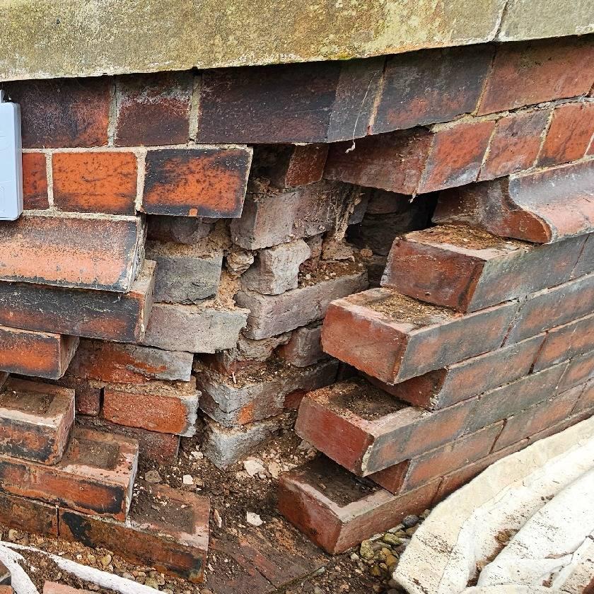 Cleaning out of cavity to stop damp on a brick bay winow