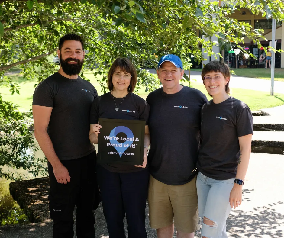 WhirLocal Salem Team holding "We're Local & Proud Of It!" sign