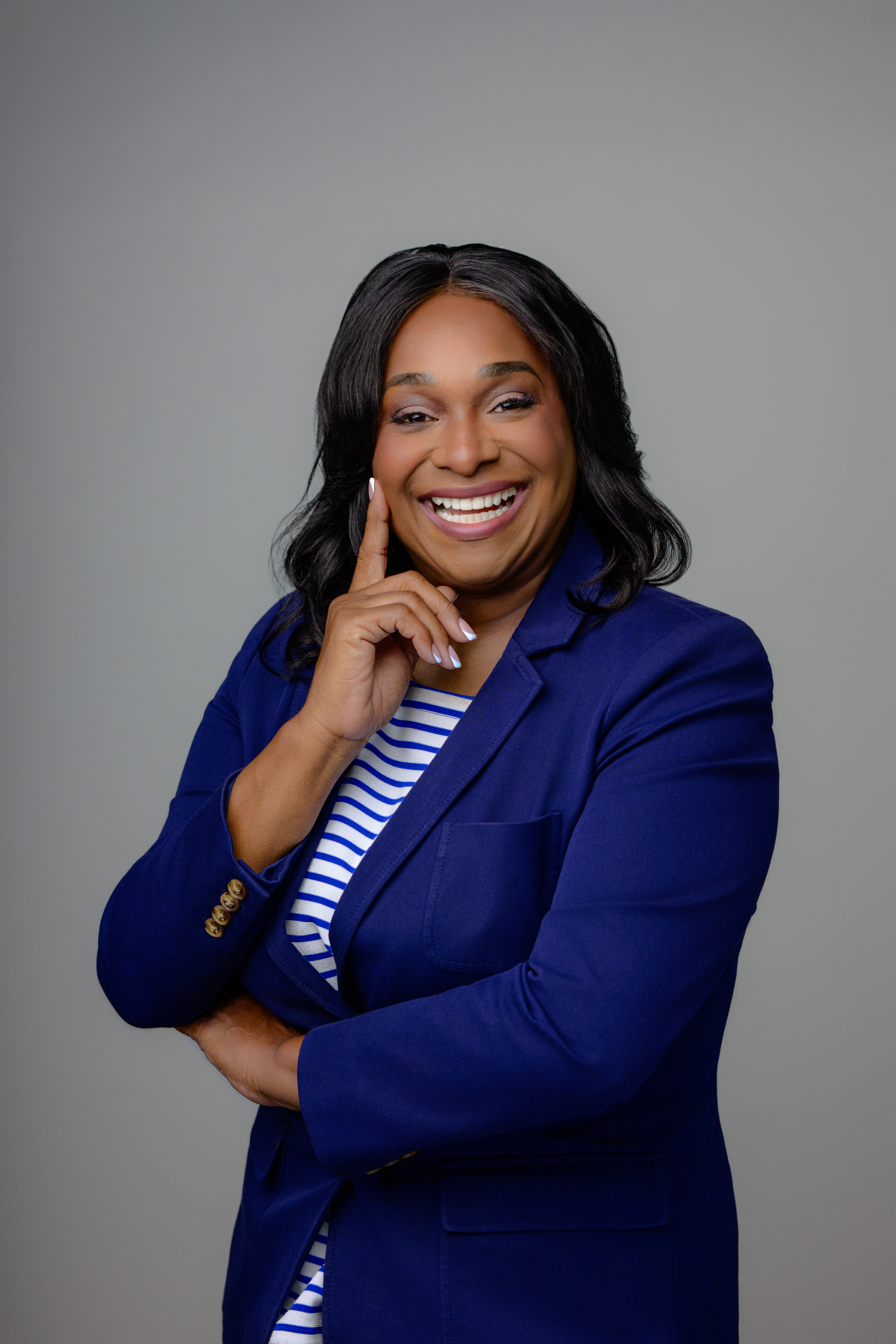 Regina Wagner, the Cash Flow Queen, wearing a blue blazer, providing financial strategy for business owners.