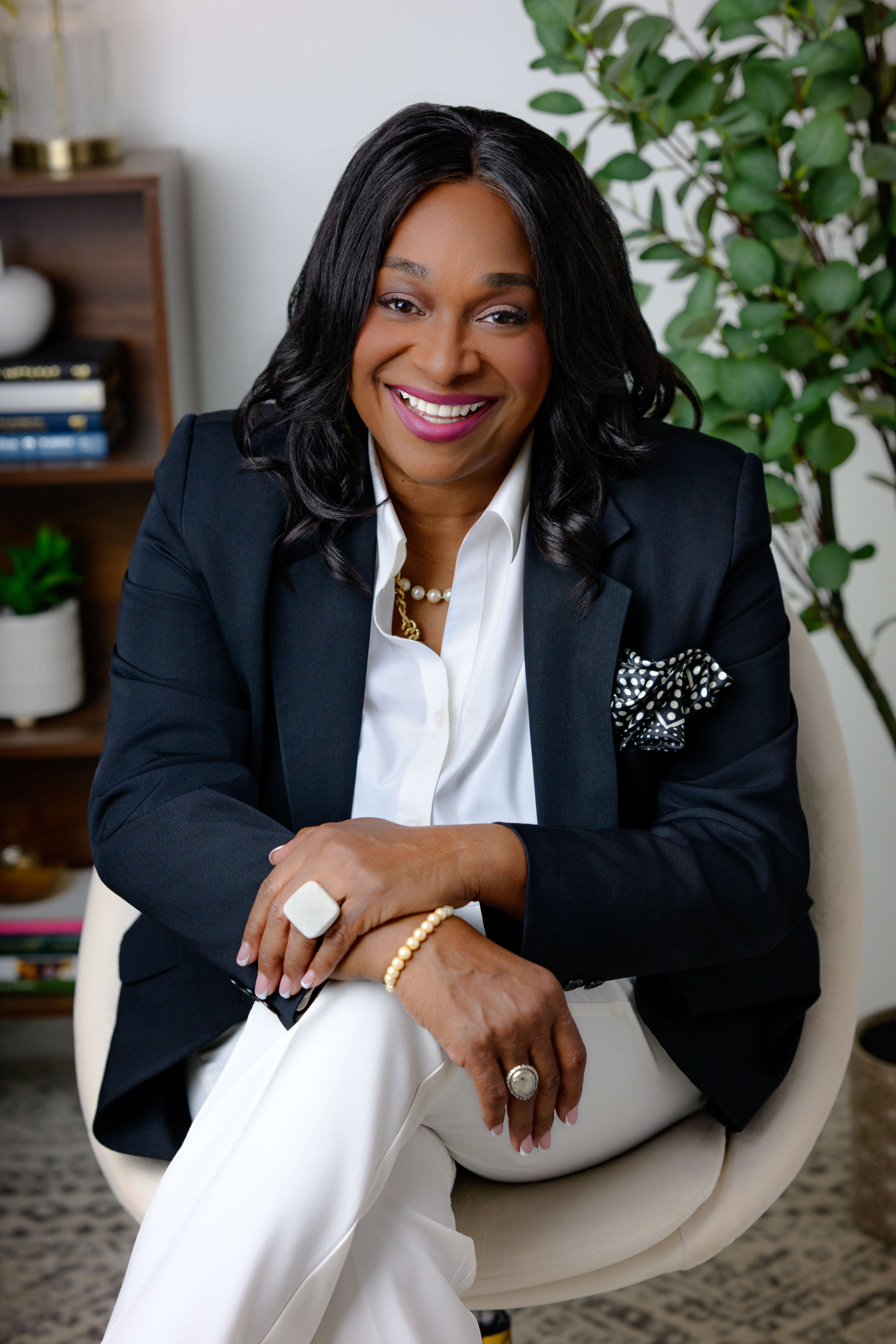 Regina Wagner, the Cash Flow Queen, wearing a professional black suit, providing financial strategy for business owners.