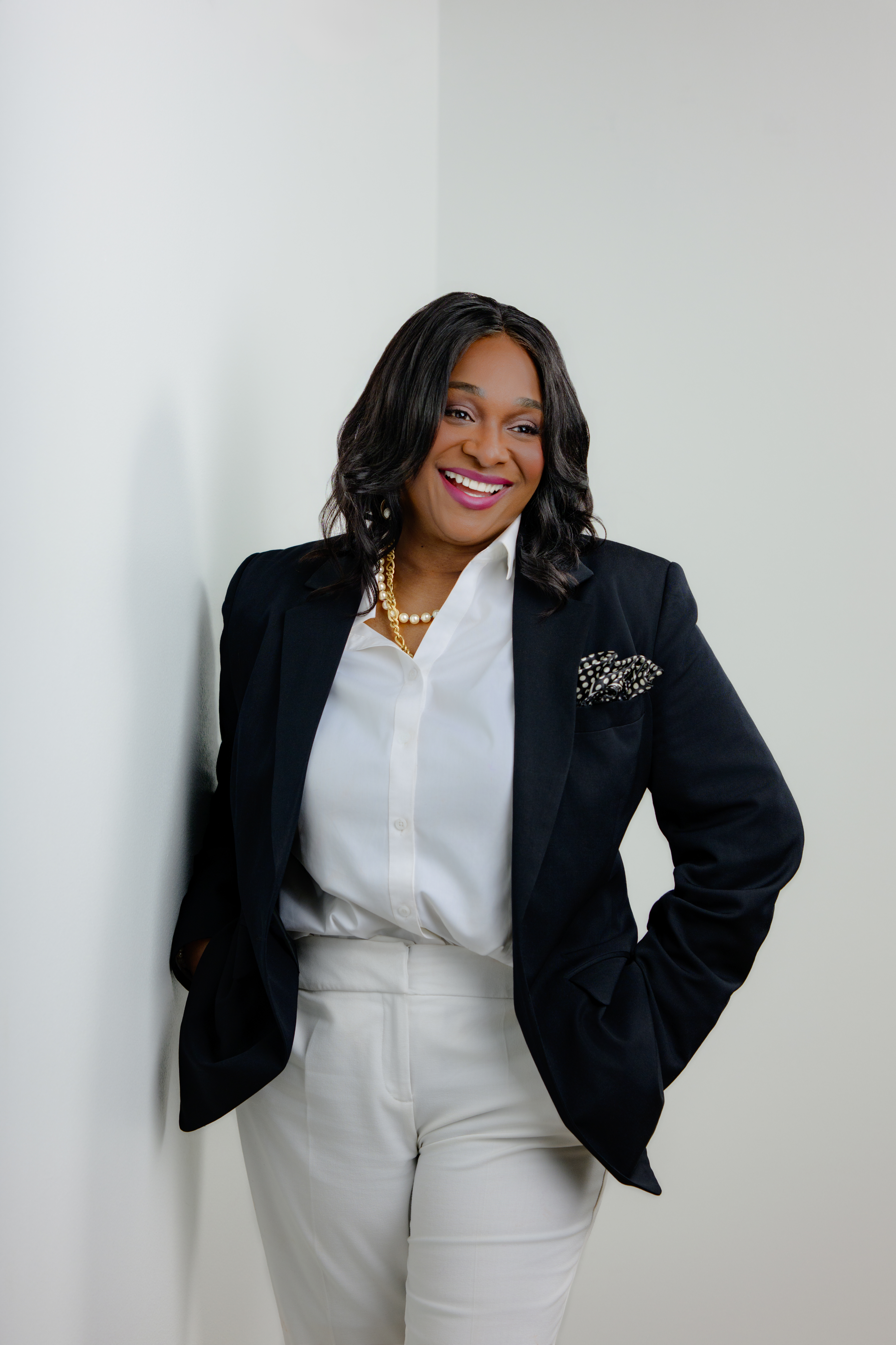 Regina Wagner, the Cash Flow Queen, wearing a professional black suit, providing financial strategy for business owners.