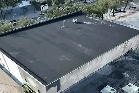 Aerial view of completed flat roof replacement on commercial building in Plymouth